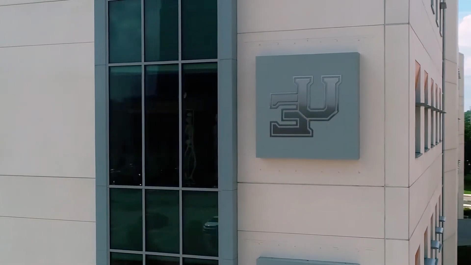 Stone Center UE sign on side of building